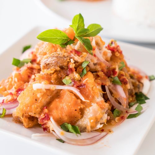 spicy salad with fried chicken on the table